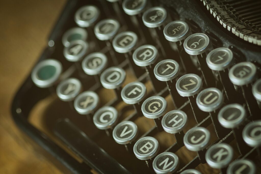 Close-up view of a vintage typewriter keyboard with round keys from an old typing device.
